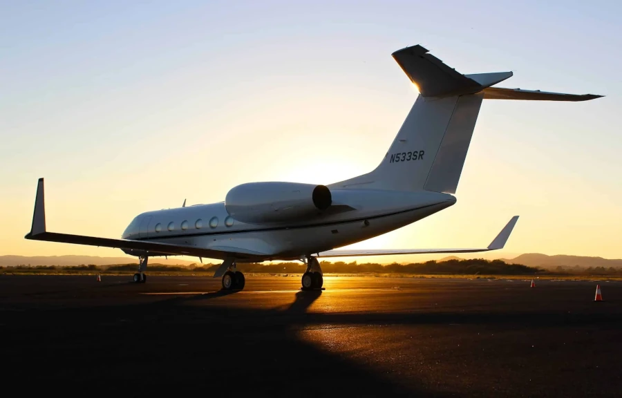 Beautiful private jet on the track with big sun in Phuket.